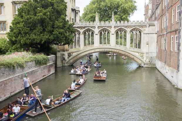 Rush hour for punts on the river Cam that threads itself below the Bridge of Sighs at St. John's College, Cambridge